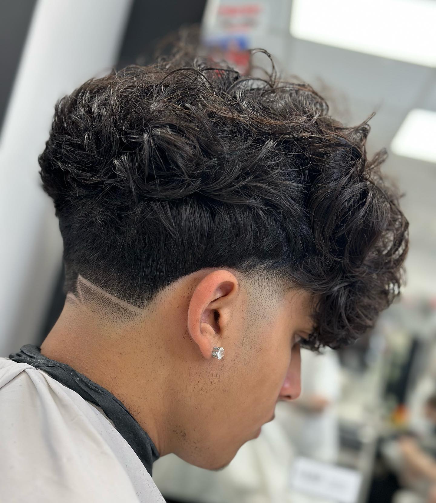 Mid-Length Curly Wavy Undercut for Guys